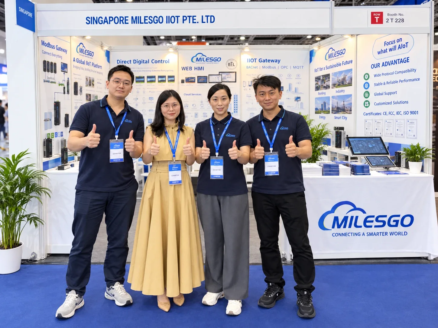 Four members of the MILESGO team at booth 2T228 at Malaysia Engineering Week 2026, in front of displays for Modbus gateways, Direct Digital Control, Web HMI and IIoT gateways.