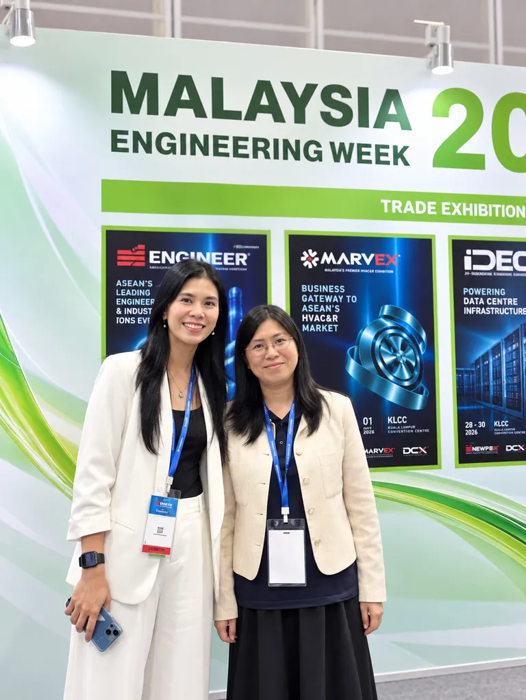 Two attendees in front of the Malaysia Engineering Week 2026 trade exhibition backdrop showing the ENGINEER, MARVEX and IDEC shows.